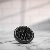 Scalp massager elegantly displayed in a styled photoshoot, highlighting its modern aesthetics.
